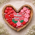Romantic heart-shaped candle filled with blooming flowers by Suryatra